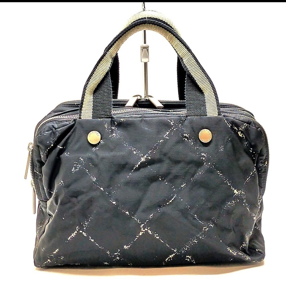 CHANEL Cream and Black Travel Bag with Elegant Design
